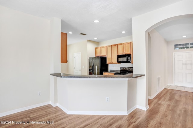 kitchen with black appliances, light brown cabinets, kitchen peninsula, and light hardwood / wood-style flooring