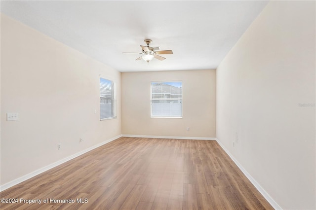 spare room featuring hardwood / wood-style flooring and ceiling fan