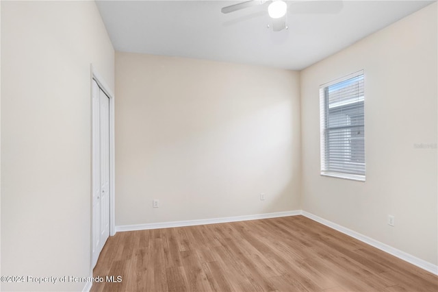 empty room with light hardwood / wood-style floors and ceiling fan