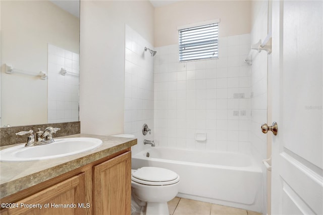 full bathroom with tile patterned flooring, vanity, tiled shower / bath combo, and toilet