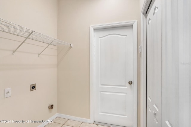 laundry room featuring hookup for an electric dryer and light tile patterned flooring