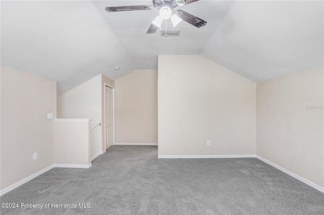 bonus room featuring light carpet, ceiling fan, and vaulted ceiling