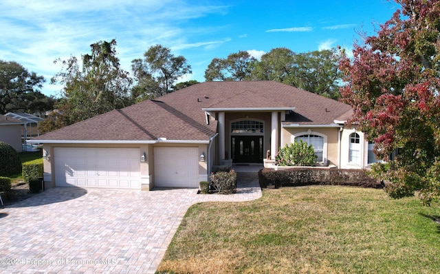 view of front of home with a garage and a front yard