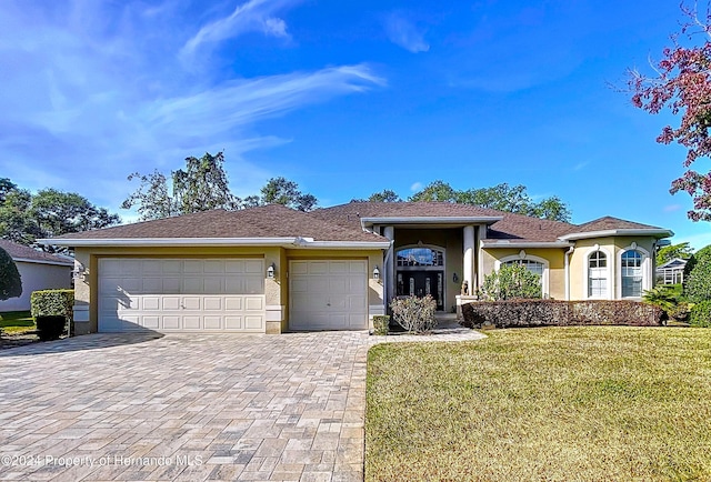 view of front of property with a front lawn and a garage