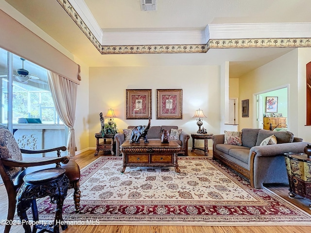 living room with ceiling fan, wood-type flooring, and crown molding