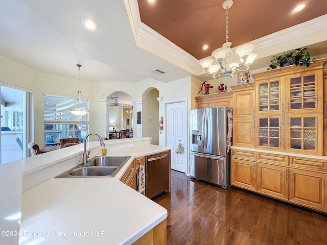 kitchen with pendant lighting, sink, ornamental molding, appliances with stainless steel finishes, and dark hardwood / wood-style flooring