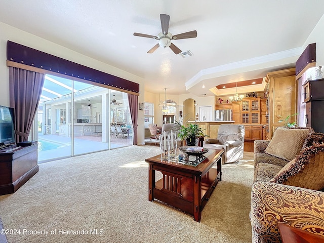 carpeted living room with ceiling fan with notable chandelier and ornamental molding