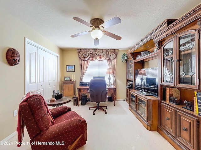 office with light carpet, a textured ceiling, and ceiling fan