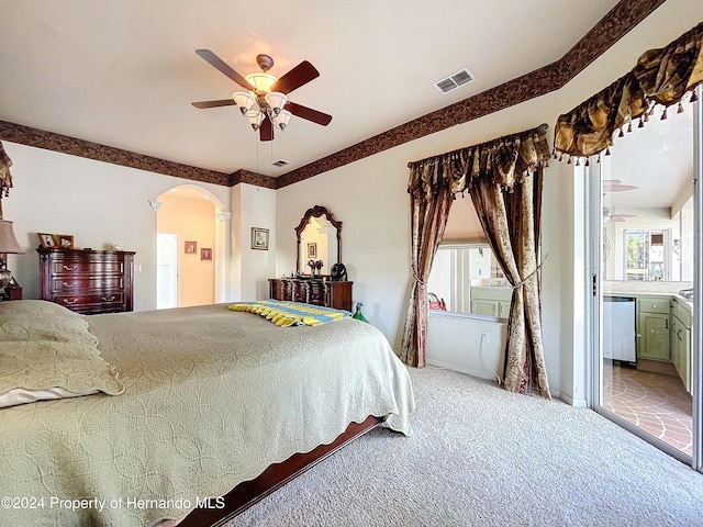 carpeted bedroom featuring ensuite bath and ceiling fan