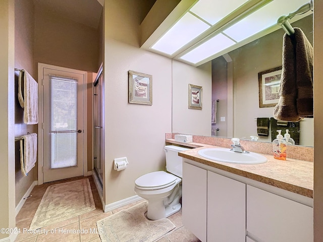 bathroom featuring tile patterned floors, vanity, and toilet