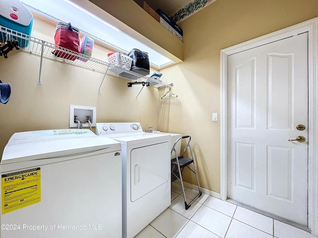 laundry room with light tile patterned floors and washing machine and clothes dryer