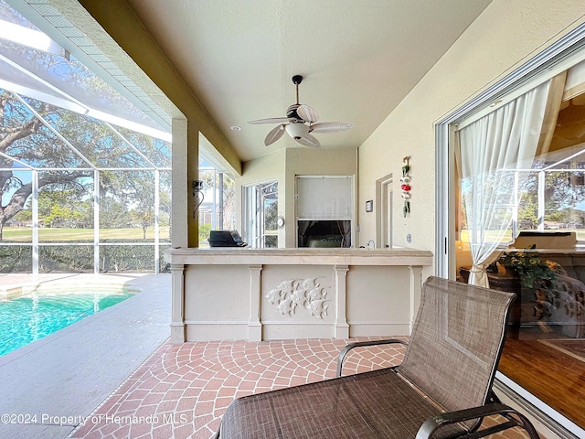 view of patio / terrace with ceiling fan and a lanai