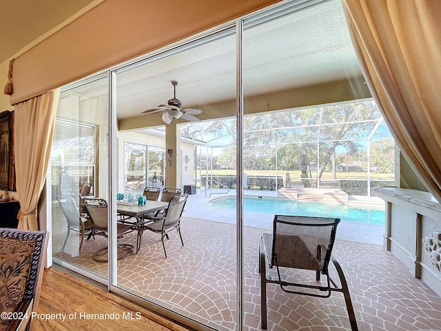 interior space with ceiling fan and a swimming pool