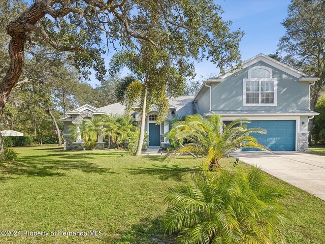 view of front of house featuring a front yard and a garage