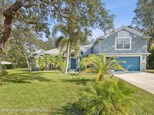 92 Randolph Ave, Spring Hill, FL 34606 - view of front of home featuring concrete driveway, a front yard, an attached garage, and stucco siding