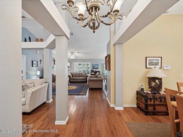 92 Randolph Ave, Spring Hill, FL 34606 - hallway with wood finished floors, a chandelier, and ornate columns
