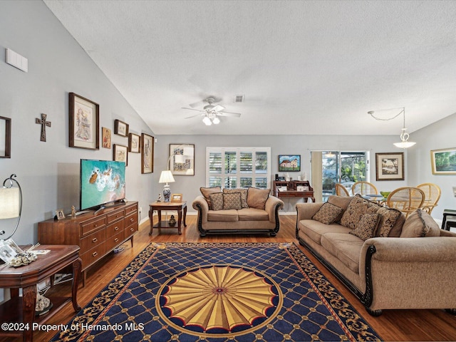 living room with a textured ceiling, ceiling fan, lofted ceiling, and hardwood / wood-style flooring