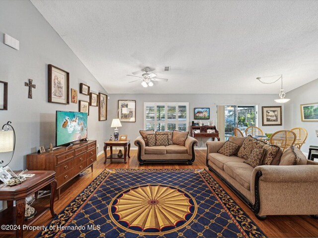92 Randolph Ave, Spring Hill, FL 34606 - living room with a textured ceiling, wood finished floors, a ceiling fan, healthy amount of natural light, and lofted ceiling