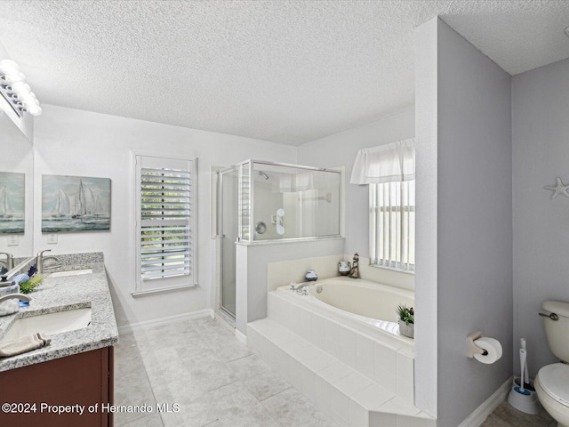 full bathroom featuring plus walk in shower, tile patterned floors, a textured ceiling, toilet, and vanity