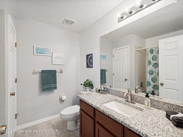 bathroom featuring tile patterned flooring, a textured ceiling, and vanity