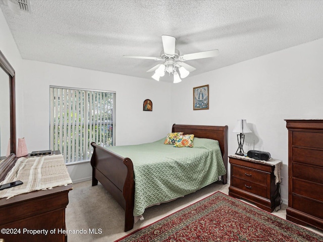 92 Randolph Ave, Spring Hill, FL 34606 - carpeted bedroom with a textured ceiling and ceiling fan