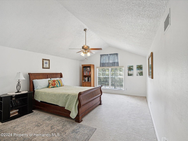 bedroom with ceiling fan, light colored carpet, a textured ceiling, and vaulted ceiling