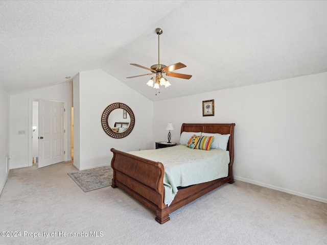 carpeted bedroom with ceiling fan, lofted ceiling, and a textured ceiling