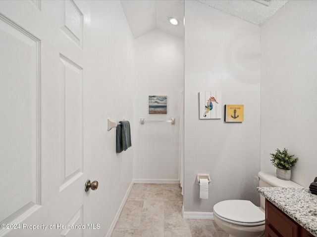 bathroom featuring tile patterned flooring, a textured ceiling, lofted ceiling, toilet, and vanity