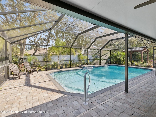 view of pool featuring a lanai and a patio