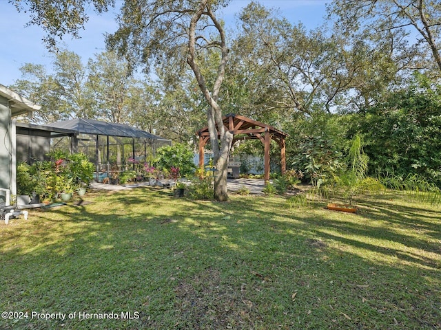 view of yard featuring a gazebo and a lanai