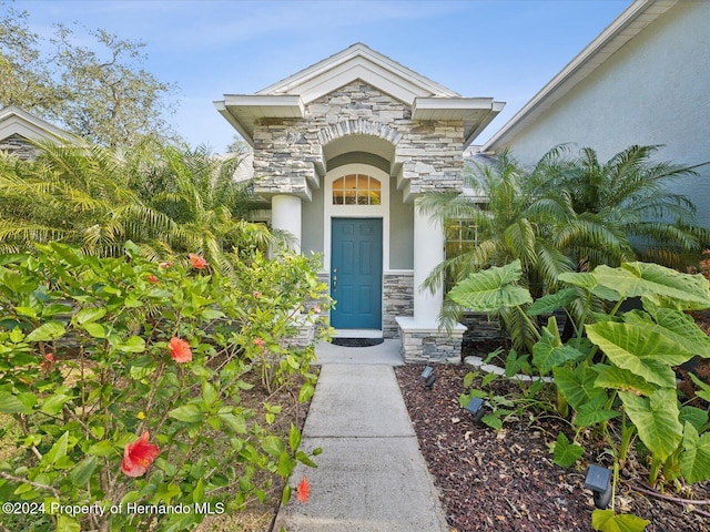 92 Randolph Ave, Spring Hill, FL 34606 - view of exterior entry with stone siding and stucco siding