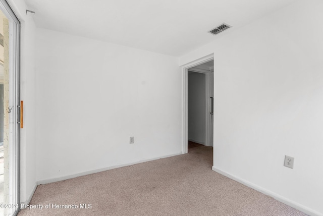 empty room featuring light colored carpet