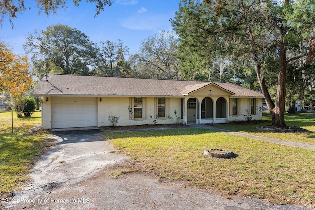 ranch-style home featuring a garage and a front yard