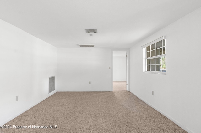 empty room featuring light colored carpet