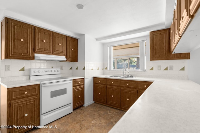 kitchen with backsplash, white range with electric cooktop, and sink