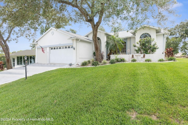 view of front facade with a front lawn and a garage