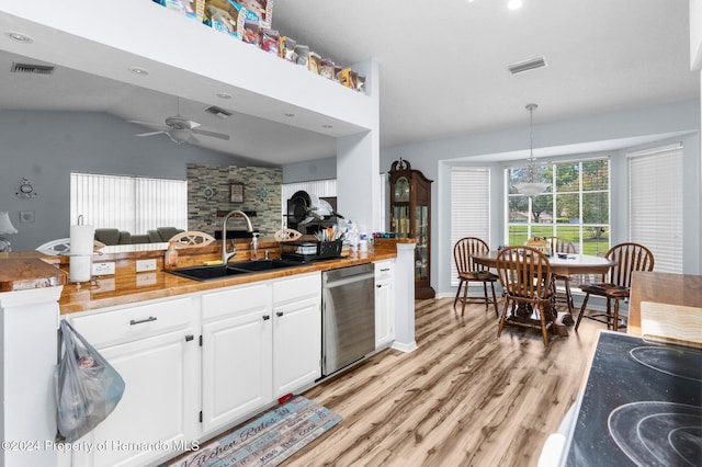 kitchen with white cabinetry, sink, hanging light fixtures, stainless steel dishwasher, and light hardwood / wood-style floors