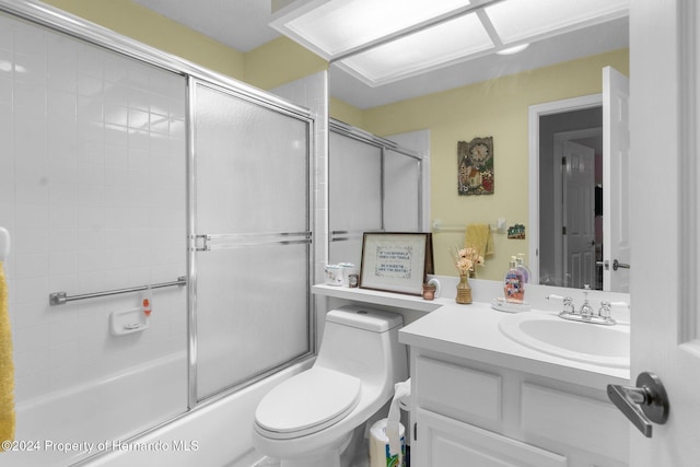 full bathroom featuring vanity, toilet, and combined bath / shower with glass door