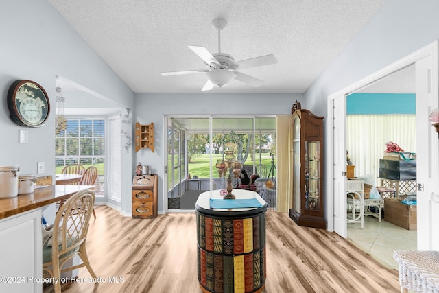 home office with light wood-type flooring, vaulted ceiling, plenty of natural light, and ceiling fan