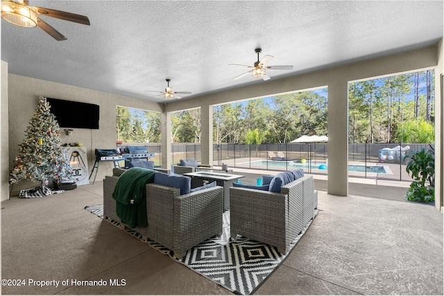 view of patio with ceiling fan and a fenced in pool