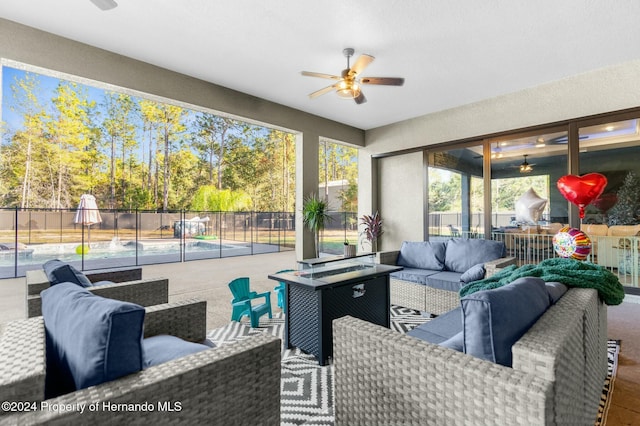 sunroom / solarium featuring ceiling fan