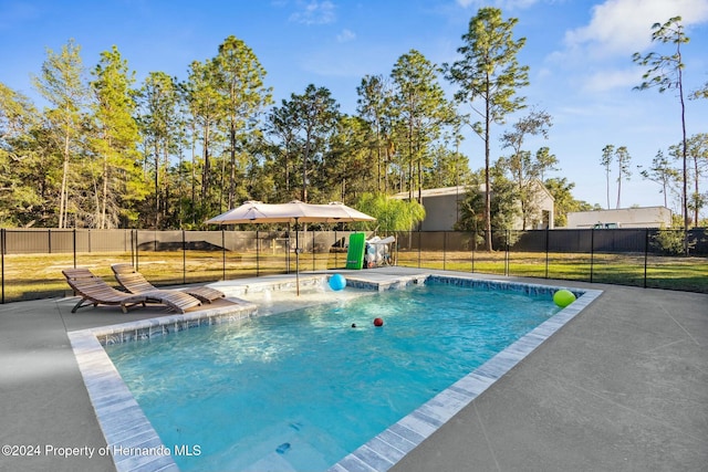 view of swimming pool with a lawn and a patio