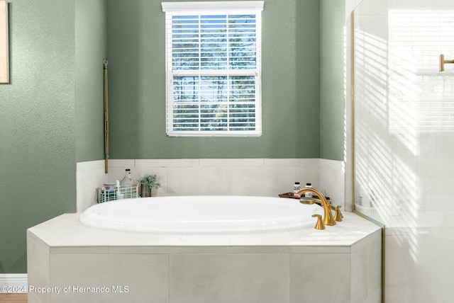 bathroom with tiled tub