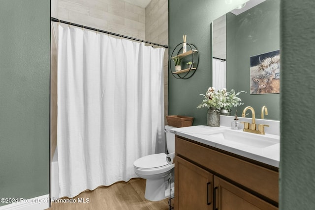 full bathroom with vanity, toilet, wood-type flooring, and shower / tub combo