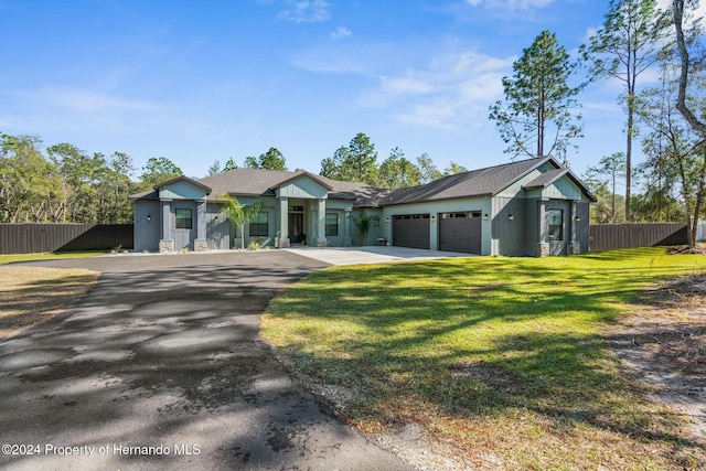 view of front of house featuring a garage and a front yard