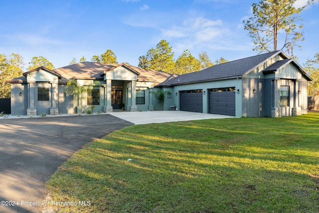 view of front facade with a garage and a front yard