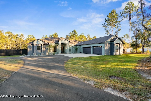 view of front of property with a garage and a front yard