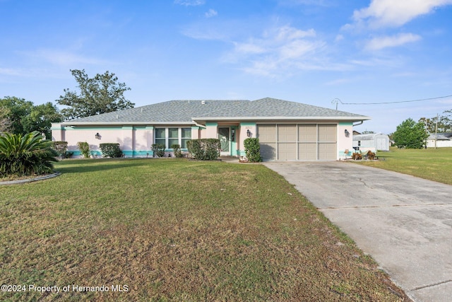 ranch-style house with a garage and a front lawn