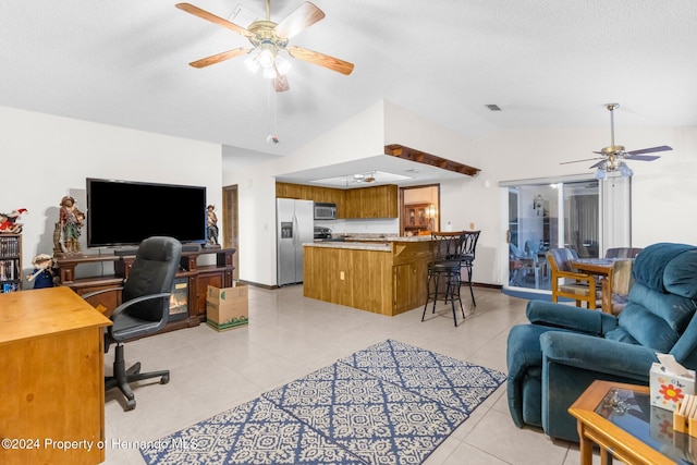 office area featuring ceiling fan, light tile patterned floors, a textured ceiling, and vaulted ceiling