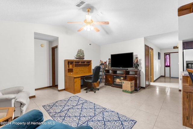 tiled office space with ceiling fan, a textured ceiling, and vaulted ceiling